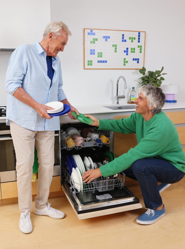 Father and son stacking a dishwasher